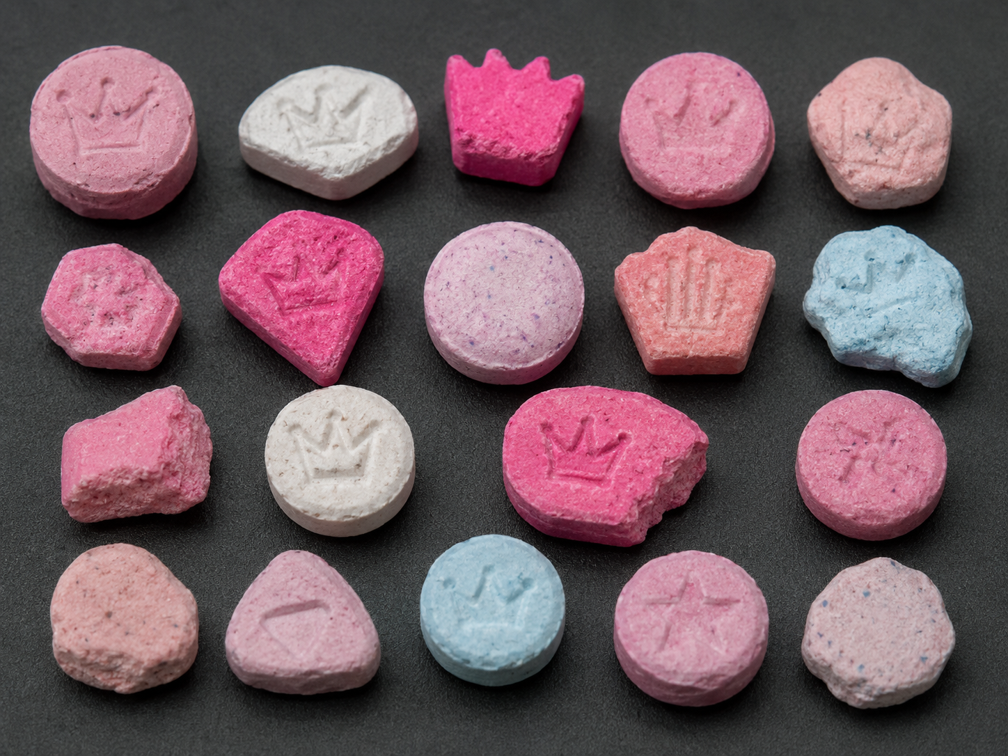 Fictional assortment of counterfeit Nova tablets in varied colors and shapes